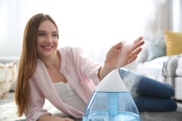 Poster - Woman near modern air humidifier at home