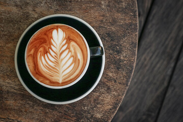 Wall Mural - A cup of coffee with latte art on top