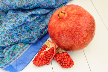 Pomegranate and two wedges with grains.