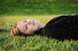 © Tamara Pruessner/Stocksy - Young Woman Laying In Grass