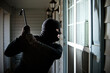 © Sean Locke Photography/Stocksy - Burglar: Guy in Mask Ready to Break Window