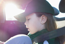 Little Girl Preparing For Baseball Game In Car Back Seat