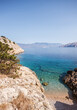 © Akela - from alp to alp/Stocksy - beautiful bay with clear water