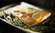 © Carolyn Lagattuta/Stocksy - Roasted salmon and asparagus on parchment paper in the oven