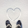 © Pixel Stories/Stocksy - Person standing in front of snow heart