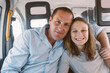 © Gillian Vann/Stocksy - father and daughter in the back of taxi, smiling candidly to camera