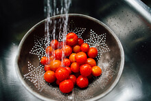 Cherry Tomatoes Being Washed In A Colandar