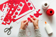 © Pixel Stories/Stocksy - Woman making diy red hearts decoration