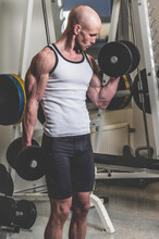 Man Lifting Weights At The Gym