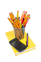 calculator, pencils and bright yellow book