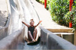 © Rob and Julia Campbell/Stocksy - Fun loving girl sliding down cement slides.