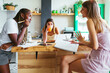 © BONNINSTUDIO/Stocksy - Multiracial friends discussing homework assignment in morning