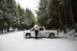 © Rob and Julia Campbell/Stocksy - Man preparing for winter surf at his truck.
