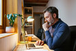 © BONNINSTUDIO/Stocksy - Thoughtful journalist using laptop in home office