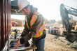 © Rob and Julia Campbell/Stocksy - Construction worker washing his hands outside on the jobsite.