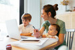 © BONNINSTUDIO/Stocksy - Happy family using the laptop at home