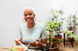 © BONNINSTUDIO/Stocksy - Cheerful black employee having healthy lunch in morning