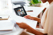 © BONNINSTUDIO/Stocksy - Crop black businesswoman examining papers during online conference