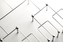 Hierarchy, Command Chain, Company / Organization Structure Or Layer And Grouping Concept Image. Top Down Structure Made From Chrome Wires And Silver Nails And Wire On White. Shallow Depth Of Field.