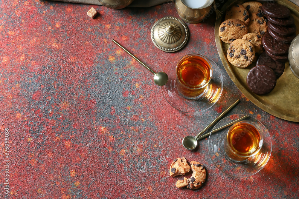 Cups of hot Turkish tea and sweets on table
