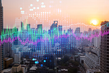 Market behavior graph hologram, sunset panoramic city view of Bangkok, popular location to achieve financial degree in Asia. The concept of financial data analysis. Double exposure.