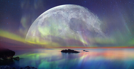 northern lights (aurora borealis) in the sky with super full moon - tromso, norway 