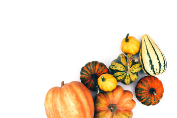 Wall Mural - Autumn flat lay on an isolated white background made of pumpkins.