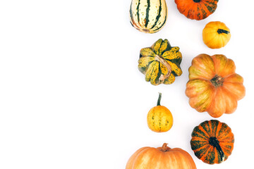 Wall Mural - Autumn flat lay on an isolated white background made of pumpkins.
