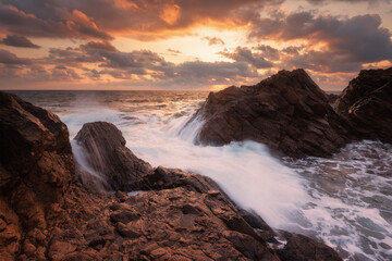 Wall Mural - Seascape during sunrise. Beautiful natural seascape. Sea sunrise at the Black Sea coast. Magnificent sunrise with clouds and fire sun at the beginning of September. Rezovo village, Bulgaria