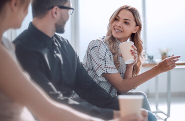 Poster - employees of the company with coffee glasses sitting in the office lobby