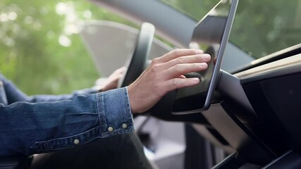 Close up of good-mintaned male hand which entering neccessary datas on gps navigator inside car