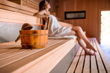 Young woman relaxing in spa using sauna