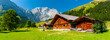 © Wolfilser - panorama landscape in alpine mountains with farmhouse