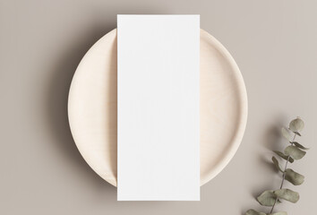 Canvas Print - Menu card mockup with a eucalyptus branch on a plate, 4x9 ratio.