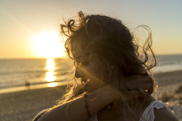 Wall Mural - Shallow focus shot of a young female on the beach