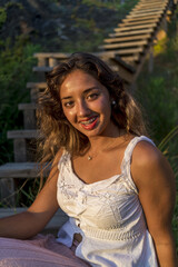 Canvas Print - Vertical shot of a young lady with beautiful long hair happily posing for a photo