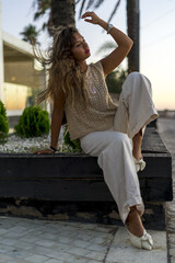 Wall Mural - Vertical shot of a young lady with beautiful long hair happily posing for a photo