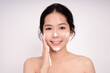 © PBXStudio - Asian woman washing face makeup with cleansing foam isolated white background