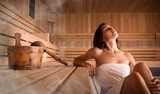 Beautiful young woman relaxing in Finnish sauna