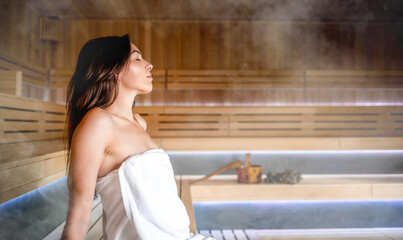 Wall Mural - Beautiful young woman relaxing in Finnish sauna