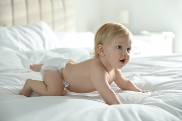 Sticker - Cute little baby in diaper on bed at home