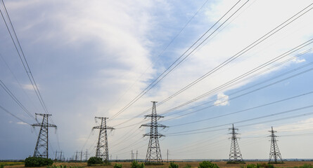 High-voltage power lines at sunset or sunrise. High voltage electric transmission tower