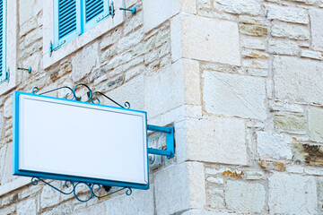 Blue store sign mockup with stone wall shiny day