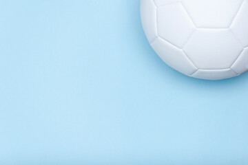 White soccer ball on blue background. Copy space. Over view.