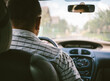 © Ilya/Stocksy - Mature man driving in car