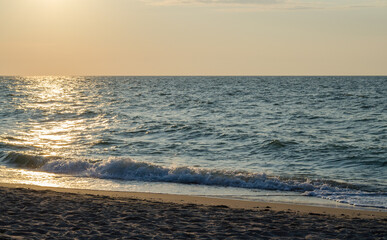 Sunset over the sea. Waves on the sea at sunset. Curonian spit, Kaliningrad region, Russia