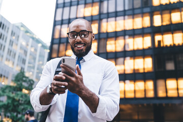 Successful black businessman using smartphone