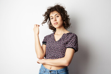 Wall Mural - Waist-up shot of friendly-looking teenage girl smiling broadly with shy and happy expression meeting new classmates.