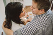 © Kristin Rogers Photography/Stocksy - Romantic couple drinking coffee in home on staircase