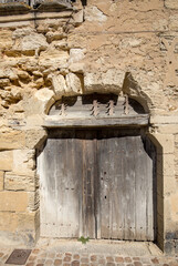 Wall Mural - Front wall of an old stone house in Saint Emilion. France.  St Emilion is one of the principal red wine areas of Bordeaux and very popular tourist destination.